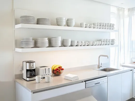 Rental kitchen with organized dinnerware shelf